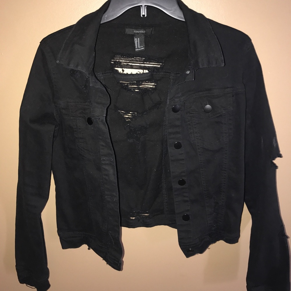 Black denim jacket with distressed back and arm.